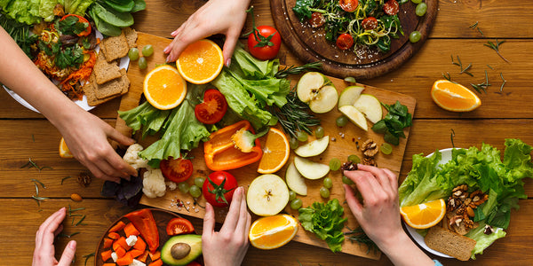 counter full of colorful fruits and vegetables 